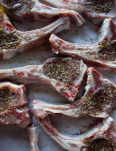 lamb chops seasoned on tray