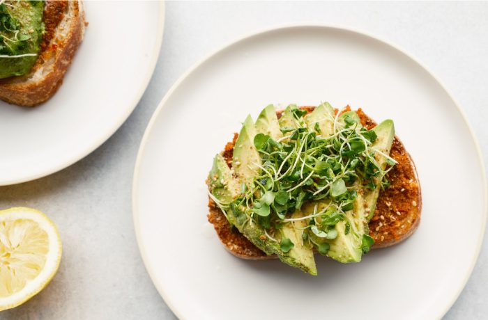 California Lamb avocado toast with microgreens on a plate