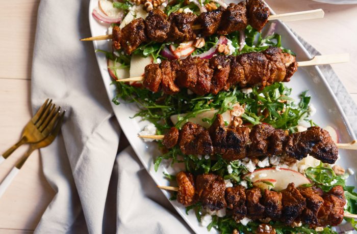 Pumpkin Spiced Lamb Kebabs served over an apple and arugula salad with walnuts, red onion, and crumbled goat cheese.