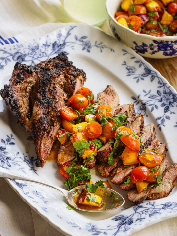 Sliced grilled American lamb served with nectarine and cherry tomato salad